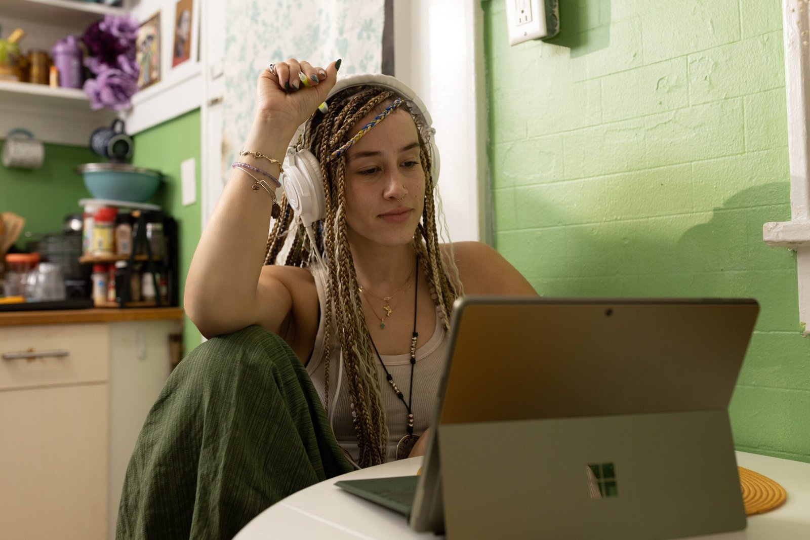 Info Tech Blogs 33 a woman with dreadlocks sitting in front of a laptop computer