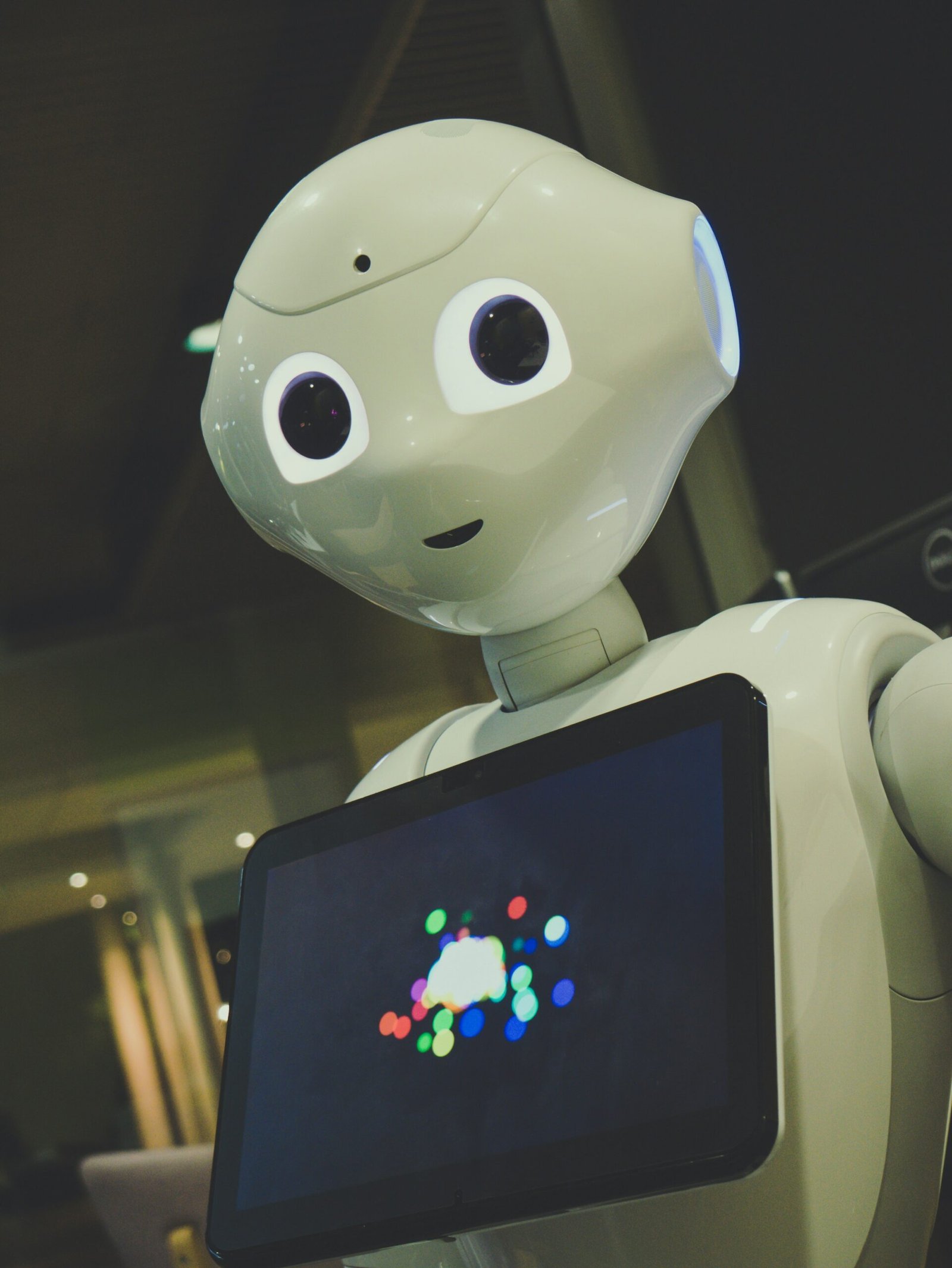 Info Tech Blogs 19 white robot toy holding black tablet