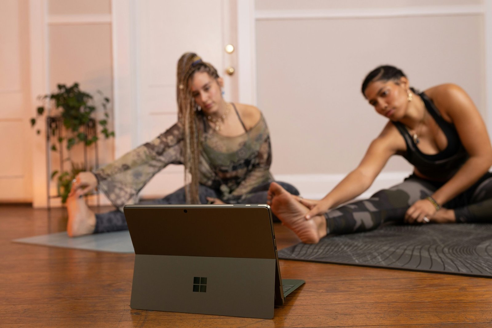 Info Tech Blogs 13 a couple of women sitting on top of a wooden floor